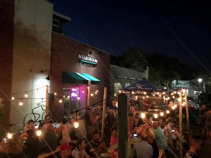 Guests enjoying an evening patio gathering at The Boardroom